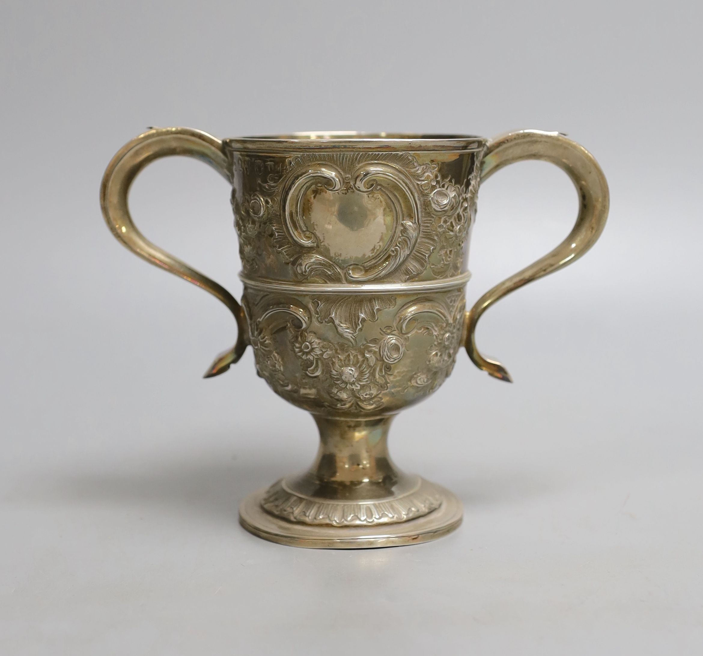 A George III provincial silver two handled pedestal cup, with later embossed decoration, Langlands & Robertson Newcastle, 1794, height 14.7cm, 10.5oz.